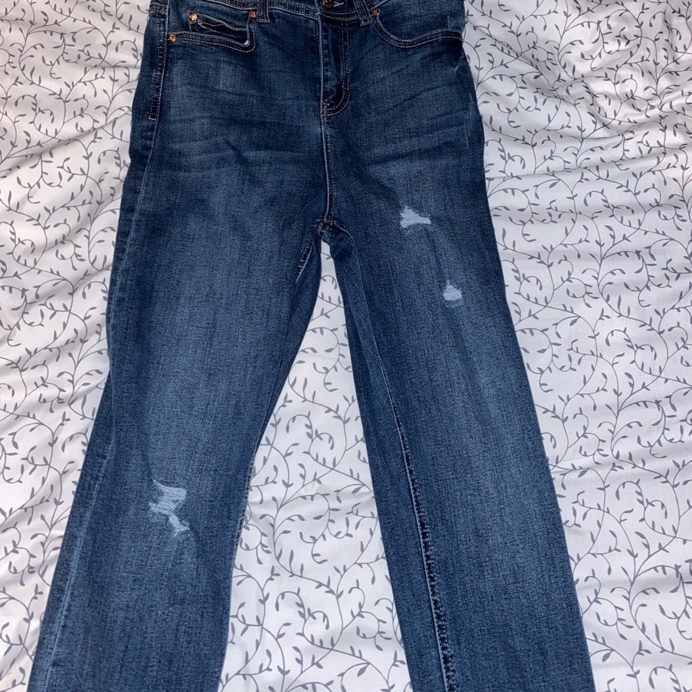 Denim skinny jean overalls with rose gold buttons.